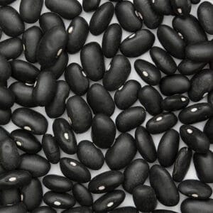 Black turtle beans on white surface